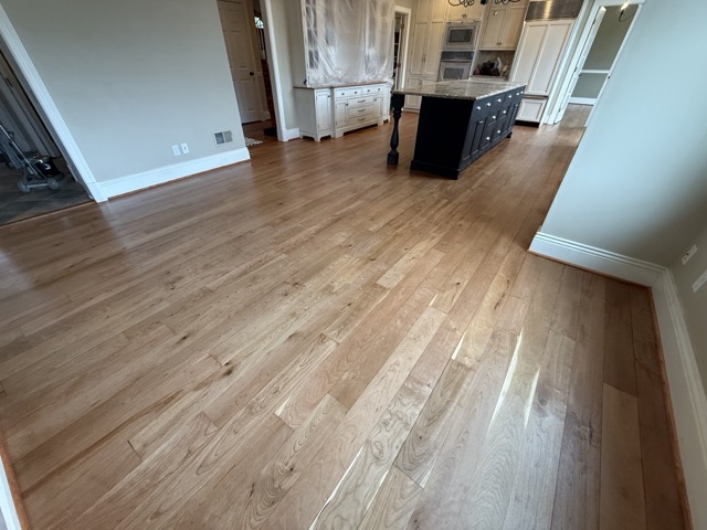 Custom hardwood floor refinishing throughout a luxury kitchen in Baltimore, MD.