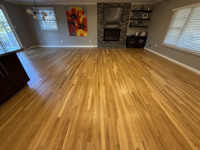 Beautifully refinished oak hardwood floors in a Baltimore, MD living room by Flawless Floors.