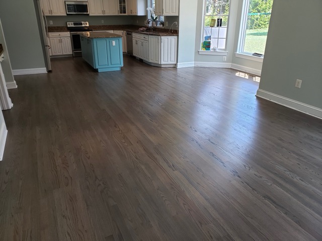 Hardwood floor refinishing completed by Flawless Floors in an open concept home in Baltimore, MD.