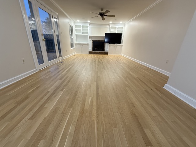 Natural oak hardwood floor refinishing completed in a Baltimore, MD living space.