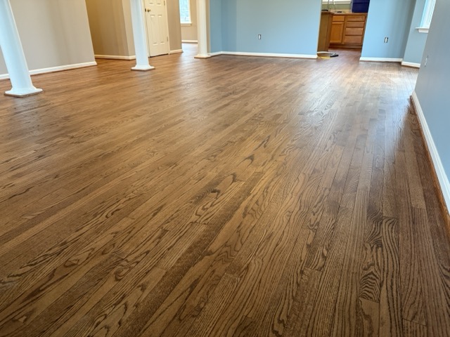Newly refinished oak hardwood flooring with a rich stain in a Baltimore, MD home.