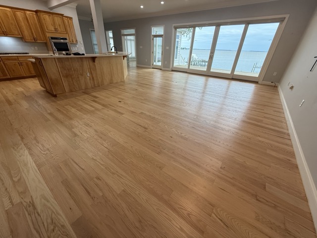 Oak hardwood floor restoration completed in a finished basement in Baltimore, MD.